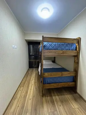 two bunk beds in a room with wood floors at Luxury apartment with panoramic view of San Isidro in Lima