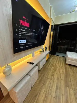 a living room with a large flat screen tv at Luxury apartment with panoramic view of San Isidro in Lima
