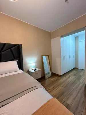 a bedroom with a bed and a mirror in it at Luxury apartment with panoramic view of San Isidro in Lima