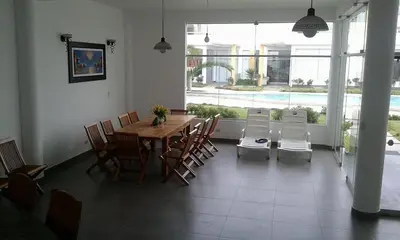 a dining room with a table and chairs and a pool at ESCAPA DE LA RUTINA Y DISFRUTA Asia - Chocaya in Asia