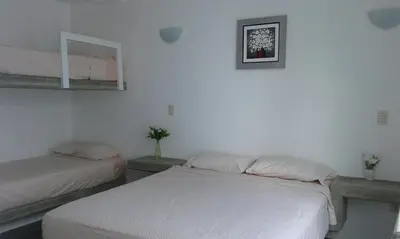 a bedroom with two beds and a mirror on the wall at ESCAPA DE LA RUTINA Y DISFRUTA Asia - Chocaya in Asia