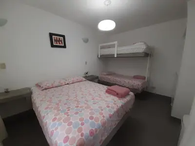 two beds in a room with two bunk beds at ESCAPA DE LA RUTINA Y DISFRUTA Asia - Chocaya in Asia