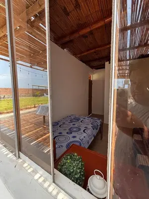a view of a room with a bed and a balcony at Casa Puente Azul - Casa de Playa in Cerro Azul