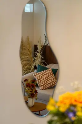 a mirror reflection of a couch in a living room at Well-Located and Modern Apartment in Barranco in Lima