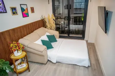 a bed in a room with a couch and a table at Well-Located and Modern Apartment in Barranco in Lima