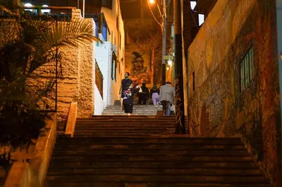 a group of people walking down stairs at night at Well-Located and Modern Apartment in Barranco in Lima