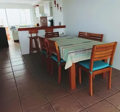a table and chairs in a kitchen with a table and a counter at Espectacular Casa de Playa en Asia frente al Mar in Asia