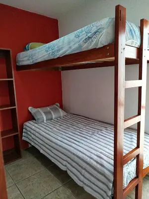 two bunk beds in a room with a bed at Espectacular Casa de Playa en Asia frente al Mar in Asia