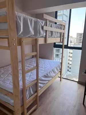 a couple of bunk beds in a room with a window at Comfortable accommodation between Lince and San Isidro in Lima