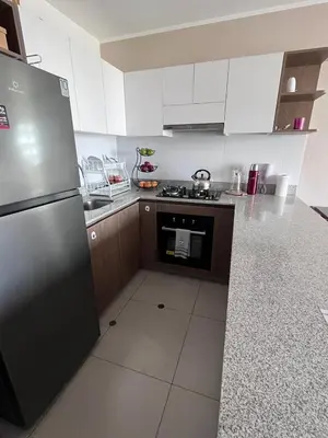 a kitchen with a stainless steel refrigerator and a stove at Comfortable accommodation between Lince and San Isidro in Lima