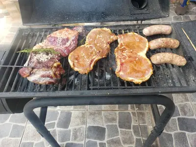 a grill with meats and sausages on it at Casa Conquista in Cusco