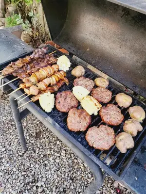 a grill with hamburgers and sausages and hamburgers and other at Casa Conquista in Cusco