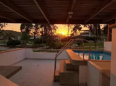 a view of a swimming pool with the sunset in the background at Bujama beach Home Family Asia in Mala