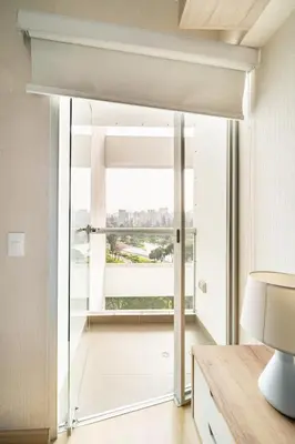 a room with a large window with a view of the city at Departamento con vista al Circuito Mágico del Agua in Lima