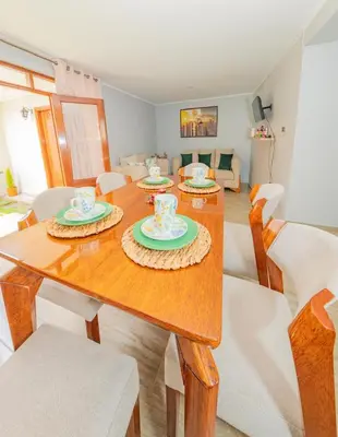 a dining room with a wooden table with chairs at La covacha de viejo in Jauja