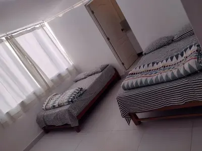 two beds sitting next to a window in a room at Macky'sThe Silence in Bombiso