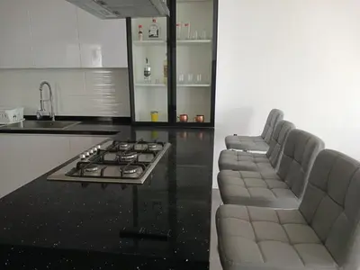 a kitchen with chairs and a stove and a counter at Macky'sThe Silence in Bombiso