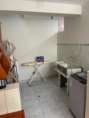 a room with a table in the corner of a kitchen at La esquina de vallecito in Cusco