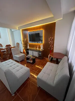 a living room with a couch and a tv at La esquina de vallecito in Cusco