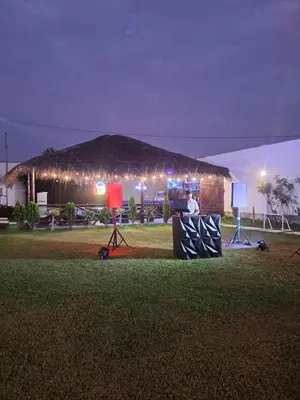 a man standing in front of a hut at night at Hotel Kendari - Chincha in Chincha