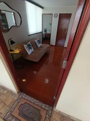 an open door to a living room with a couch at La Palmera in Lima