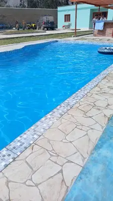 a swimming pool with blue water at Villa MAS - Condominio Hacienda II in Pachacamac