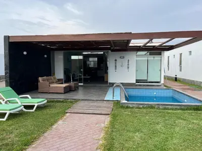 a house with a swimming pool and a patio at Linda Casa en Condominio in Asia