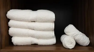 a stack of white towels sitting on a shelf at La Casona Real Cusco in Cusco