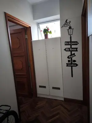 a hallway with a door with a sign on the wall at Lindo apartmento en PLAZA PRINCIPAL in Lima