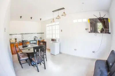 a kitchen and dining room with a table and chairs at Edelweisshaus Chontabamba in Oxapampa