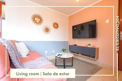 a living room with a couch and a flat screen tv at Vibrant Exclusive 1BR Apt in front of Casa Andina in Lima