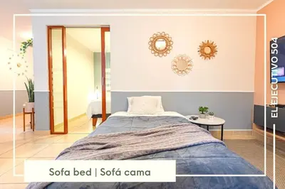 a bedroom with a bed and a mirror at Vibrant Exclusive 1BR Apt in front of Casa Andina in Lima