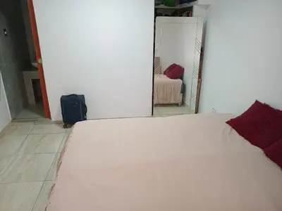 a bedroom with a white bed and a mirror at Colibri in Lima