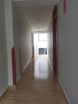 an empty hallway with a large window in a building at Retama Lodging in Cusco