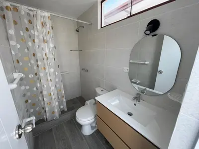 a bathroom with a sink and a toilet and a mirror at Casa de campo en condo cerca a playa Puerto Viejo in San Antonio