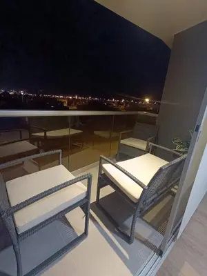 a balcony with chairs and a view of the city at Rosita del Mar in San Bartolo