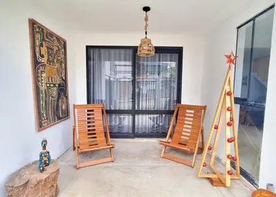 a room with two wooden chairs and a window at Casa Qiru tu Refugio en Oxapampa in Oxapampa