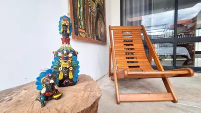 a pair of figurines sitting on top of a wooden table at Casa Qiru tu Refugio en Oxapampa in Oxapampa