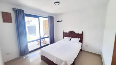 a bedroom with a bed and a large window at Casa Qiru tu Refugio en Oxapampa in Oxapampa