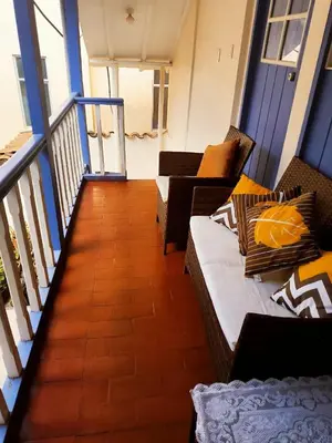 a living room with two couches on a balcony at Casa Centro Historico Cusco in Cusco