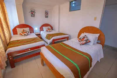 a room with two beds in a room at AloInkaHotels in Cusco