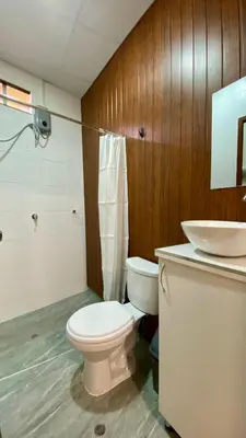 a bathroom with a white toilet and a sink at Templo de la Luna Pardo in Cusco