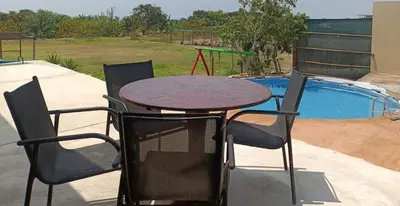 a table and chairs next to a swimming pool at Casa EN ASIA in Asia
