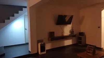 a living room with a staircase and a television at Casa EN ASIA in Asia