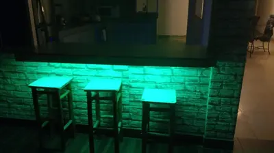 two bar stools in front of a brick wall at Casa EN ASIA in Asia