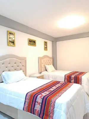 a hotel room with two beds in a room at Samin House in Cusco