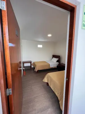 a room with two beds and a door open at Boulevard Hotel in Asia