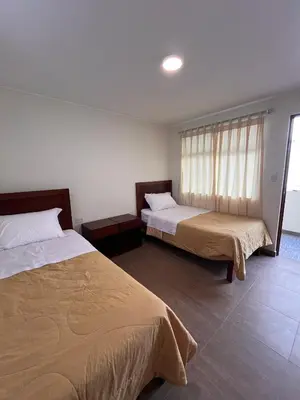 a bedroom with two beds and a window at Boulevard Hotel in Asia