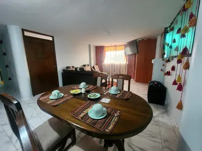a dining room table and chairs in a living room at Casa Mirador SanBlas Quilla in Cusco