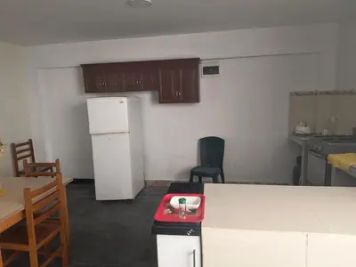 a kitchen with a white refrigerator and a red scale at Dpto Familiar en San Bartolo in San Bartolo